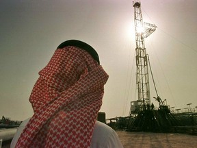FILE - In this Feb. 26, 1997 file photo, Khaled al-Otaiby, an official of the Saudi oil company Aramco, watches progress at a rig at the al-Howta oil field near Howta, Saudi Arabia. According to an assessment published Monday, April 1, 2019, by Moody's Investors Services, the net profits of Saudi Aramco reached $111 billion last year. That places Aramco ahead of some of the world's most profitable firms. In their first-ever grade assessment for Aramco, Fitch Ratings issued the firm an A+ rating, while Moody's gave it it's A1 rating ahead of its upcoming bonds sale.