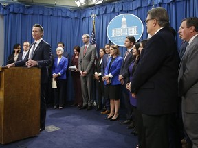 California Gov. Gavin Newsom, left, flanked by lawmakers from both houses of the legislature, discusses the weekend shooting at the Poway Chabad Synagogue north of San Diego during a news conference Monday, April 29, 2019, in Sacramento, Calif. Newsom said he would increase spending to pay for increasing security at nonprofit organizations at higher risk because of their ideology, beliefs or mission.