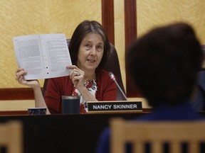 State Sen. Nancy Skinner, D-Berkeley, chairwoman of the Senate public safety committee, displays a copy of Democratic state Sen. Anna Caballero's police-backed law enforcement training bill during a hearing at the Capitol Tuesday, April 23, 2019, in Sacramento, Calif. Lawmakers worked to find common ground between law enforcement organizations, which support Caballero's bill and reformers supporting a competing measure, by Democratic Assemblywoman Shirley Weber, that would adopt the first-in-the-nation standards designed to limit fatal shootings by police.
