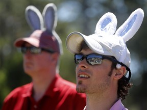 Zach Kurtz, at right, and his father Tom Kurtz, both from Cincinnati, wear Easter Bunny ears as they watch the leaders on the practice green during the final round of the RBC Heritage golf tournament at Harbour Town Golf Links on Hilton Head Island, S.C., Sunday, April 21, 2019.