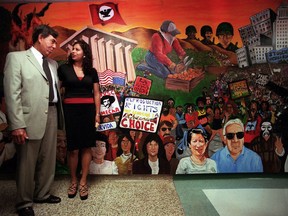 FILE - In this May 9, 2000 file photo, Mexican opposition candidate Cuauhtemoc Cardenas, left, of the Democratic Revolution Party, poses for a photo with Candy Angel, right, president of the Mexican American student group, MEChA, during a visit to the Chicano Studies Department at California State University-Northridge in Los Angeles. MEChA, a Mexican American student group founded 50 years ago, is considering a name change, highlighting the divisions between older civil rights advocates and younger activists. Student leaders voted Sunday, March 31, 2019, in Los Angeles to drop the reference to "Chicano" and "Aztlan" from the group's full name Movimiento Estudiantil Chicanx de Aztlan.