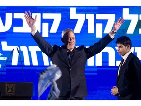 Blue and White party leader Benny Gantz waves as he speaks during an election campaign rally to his supporters in Tel Aviv, Israel, Sunday, April 7, 2019.