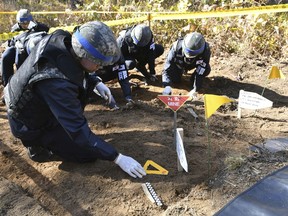 FILE - In this Oct. 25, 2018, file photo, members of South Korea's Defense Ministry recovery team work on recovering the remains of soldiers killed in the Korean War, in the Demilitarized Zone (DMZ) dividing the two Koreas in Cheorwon, South Korea. South Korea's military on Monday, April 1, 2019, is separately searching for Korean War remains at the heavily armed inter-Korean border after North Korea ignored its calls to carry out a previously planned joint search.