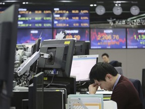 A currency trader rubs his eyes at the foreign exchange dealing room of the KEB Hana Bank headquarters in Seoul, South Korea, Friday, April 5, 2019. Shares are mixed in Asia, with Chinese markets closed for a holiday. Japan's benchmark Nikkei 225 rose early Friday while South Korea was flat and shares fell in Australia and New Zealand.