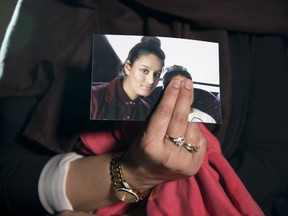 Renu Begum, eldest sister of Shamima Begum, 15, holds her sister's photo as she is interviewed by the media at New Scotland Yard, as the relatives of three missing schoolgirls believed to have fled to Syria to join Islamic State have pleaded for them to return home, on February 22, 2015 in London, England.