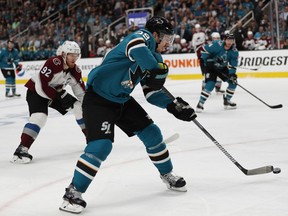 Colorado Avalanche's Gabriel Landeskog (92) chases the San Jose Sharks' Logan Couture (39), as he moves the puck downice in the first period of Game 2 of an NHL hockey second-round playoff series at the SAP Center in San Jose, Calif., on Sunday, April 28, 2019.