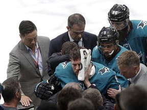 San Jose Sharks center Joe Pavelski, bottom center, is helped off the ice during the third period of Game 7 of an NHL hockey first-round playoff series against the Vegas Golden Knights in San Jose, Calif., Tuesday, April 23, 2019.