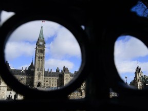 Parliament Hill is pictured through an iron fence in Ottawa on Thursday, April 4, 2019.