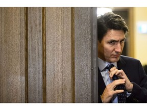 Prime Minister Justin Trudeau adjusts his tie as he leaves a cabinet meeting on route to vote in the House of Commons on Parliament Hill in Ottawa on Tuesday, April 9, 2019.