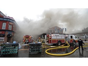 Firefighters battle a blaze at the Byward Market in Ottawa, Friday, April 12, 2019.