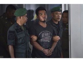 Thai suspect Ronnakorn Romruen, 23 years old, is escorted by police as he arrives at the Koh Sichang police station in Chonburi province, Thailand, Monday, April 9, 2019. Ronnakorn has been charged with the rape and murder of a German tourist on the island of Sichang. (AP Photo)