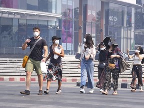 Tourists wear masks in Chiang Mai province, Thailand, Tuesday, April 2, 2019. The air hanging over Thailand's far north has become so polluted, the prime minister went Tuesday to see in person what's been called a severe health crisis.