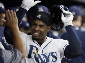 Tampa Bay Rays' Yandy Diaz celebrates in the dugout after his home run off Baltimore Orioles pitcher David Hess during the third inning of a baseball game Wednesday, April 17, 2019, in St. Petersburg, Fla.