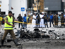Sri Lankan security personnel inspect the debris of a car after it exploded when police tried to defuse a bomb near St. Anthony's Shrine in Colombo on April 22, 2019, a day after the series of bomb blasts targeting churches and luxury hotels in Sri Lanka.