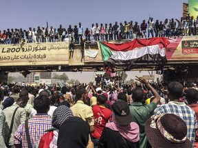 Protesters rally near the military headquarters, Tuesday, April 9, 2019, in the capital Khartoum, Sudan. Activists behind anti-government protests in Sudan say security forces have killed at least seven people, including a military officer, in another attempt to break up the sit-in outside the military headquarters in Khartoum. A spokeswoman for the Sudanese Professionals Association, said clashes erupted again early Tuesday between security forces and protesters who have been camping out in front of the complex in Khartoum since Saturday. (AP Photo)