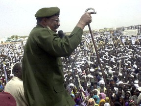 FILE - In this May 19, 2004 file photo, then Sudanese President Omar al-Bashir speaks to thousands of Sudanese in Nyala, capital of the country's southern Darfur state. Al-Bashir, driven from power in April 2019, and now languishing in a prison where his opponents were once jailed and tortured, is more vulnerable than ever to a decade-old international arrest warrant for war crimes committed in Darfur. But the military, which forced him from power after four months of mass protests, has said it will not extradite him to the International Criminal Court at the Hague.