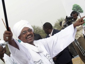 FILE - In this May 1, 2010 file photo, then Sudanese President Omar el-Bashir greets his supporters during a rally at a fair in Khartoum, Sudan. A Sudanese official and a former minister said Wednesday, April, 17, 2019, that the military has transferred ousted President Omar al-Bashir to the city's Kopar Prison in Khartoum. The move came after organizers of the street protests demanded the military move al-Bashir to an official prison.