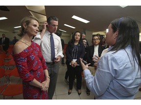 California Gov. Gavin Newsom with his wife, Jennifer Siebel Newsom, left, are welcomed by Ana Solorzano, head of the Department for Migrant Care, DGME, right, as they visit La Chacra Immigration Center in San Salvador, El Salvador, Monday, April 8, 2019. Third from left is California State Assemblywoman Wendy Carrillo.