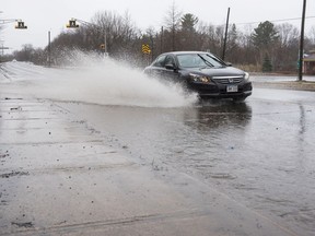 Streets and sidewalks are flooded from heavy rain on Foresthill Road in Fredericton, N.B. on Saturday, April 20, 2019.