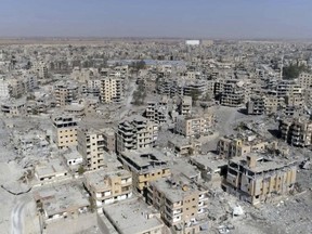 This Oct. 19, 2017 file photo, a frame grab made from drone video, shows damaged buildings in Raqqa, Syria.