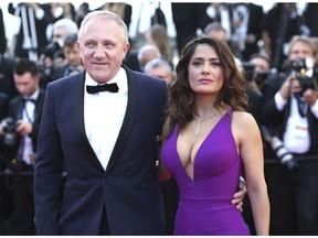 FILE - In this Sunday, May 17, 2015 file photo Francois-Henri Pinault and Salma Hayek pose for photographers upon arrival for the screening of the film Carol at the 68th international film festival, Cannes, southern France. Businessman Francois-Henri Pinault and his billionaire father Francois Pinault said they were immediately giving 100 million euros from their company, Artemis, to help finance repairs to fire damaged Notre Dame cathedral. A statement from Francois-Henri Pinault said "this tragedy impacts all French people" and "everyone wants to restore life as quickly as possible to this jewel of our heritage."