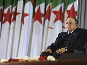 FILE - In this April 28, 2014 file photo, Algerian President Abdelaziz Bouteflika sits on a wheelchair after taking oath as President, in Algiers. Embattled Algerian President Abdelaziz Bouteflika says he will step down before his fourth term ends on April 28. In a short statement issued on Monday April 1, 2019, the president's office said Bouteflika would take "important steps to ensure the continuity of the functioning of state institutions" during a transition period following his departure from the post he's held since 1999.