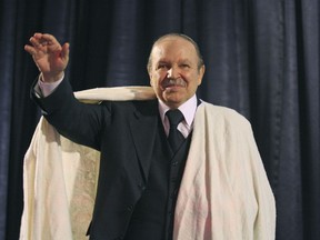 FILE - In this March 27, 2009 file photo Algerian President Abdelaziz Bouteflika salutes the crowd while dressed in a traditional "Burnous" robe from the Kabyle ethnic minority in Tizi Ouzou, Algeria. Embattled Algerian President Abdelaziz Bouteflika says he will step down before his fourth term ends on April 28. In a short statement issued on Monday April 1, 2019, the president's office said Bouteflika would take "important steps to ensure the continuity of the functioning of state institutions" during a transition period following his departure from the post he's held since 1999.