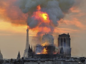 In this image made available on Tuesday April 16, 2019 flames and smoke rise from the blaze at Notre Dame cathedral in Paris, Monday, April 15, 2019. An inferno that raged through Notre Dame Cathedral for more than 12 hours destroyed its spire and its roof but spared its twin medieval bell towers, and a frantic rescue effort saved the monument's "most precious treasures," including the Crown of Thorns purportedly worn by Jesus, officials said Tuesday.