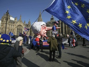 Anti-Brexit demonstrators near College Green at the Houses of Parliament in London, Monday, April 1, 2019.  Britain's Parliament gets another chance Monday to offer a way forward on Britain's stalled divorce from the European Union, holding a series of votes on Brexit alternatives in an attempt to find the elusive idea that can command a majority.