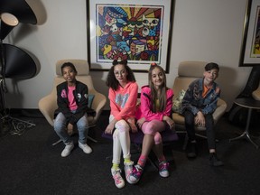 Mini Pop Kids, left to right, Eliseo Rodriguez, Avery Da Cunha, Jazzy Fauchere, and Carter Leynes pose for a photo at the YTV Corus office in Toronto on Tuesday, April 23, 2019.