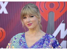 FILE - In this March 14, 2019, file photo, Taylor Swift arrives at the iHeartRadio Music Awards at the Microsoft Theater in Los Angeles. Swift says the efforts of a Tennessee LGBTQ advocacy group to fight against a handful of contentious bills moving inside the state's GOP-controlled General Assembly inspired her to make a sizeable donation.