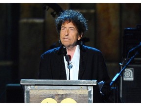 FILE - In this Feb. 6, 2015 file photo, Bob Dylan accepts the 2015 MusiCares Person of the Year award at the 2015 MusiCares Person of the Year show in Los Angeles.  Dylan is set to help open a whiskey distillery in fall 2020 under the brand "Heaven's Door."