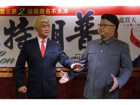 FILE - In this March 1, 2019, file photo, Hong Kong actors Chan Hung-chun, right, and Lung Koon-tin, dressed as North Korean leader Kim Jong Un and U.S. President Donald Trump, pose during a press conference to promote their upcoming Chinese opera "Trump on Show" in Hong Kong. President Trump is the inspiration for "Trump on Show," a four-day Cantonese opera that reimagines the president's personal life and his fictional twin brother who lives in China.