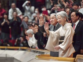 In this Jan. 20, 2019, photo,  Japanese Emperor Akihito, front left, and Empress Michiko, front right,  acknowledge the crowd during their visit to the New Year Grand Sumo Tournament at Ryogoku Kokugikan in Tokyo. The love many in Japan feel for Akihito was on full display when he made his last official visit to the winter sumo tournament earlier this year. A huge crowd of people leapt to their feet, whooping and grinning as they held up babies and waved flags.(Kyodo News via AP)