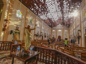 FILE - This Sunday, April 21, 2019, file photo shows the inside of St. Sebastian's Church damaged in blast in Negombo, north of Colombo, Sri Lanka. The deadly Easter attacks in Sri Lanka are a bloody echo of decades past in the South Asian island nation, when militants inspired by attacks in the Lebanese civil war helped develop the suicide bomb vest.