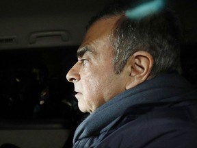 In this April 3, 2019 photo, former Nissan Chairman Carlos Ghosn in a car leaves his lawyer's office in Tokyo. Japanese prosecutors took Ghosn for questioning Thursday, April 4, 2019, barely a month after he was released on bail ahead of his trial on financial misconduct charges.