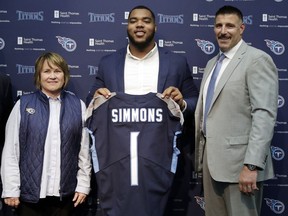 Mississippi State defensive tackle Jeffery Simmons, center, poses with Tennessee Titans owner Amy Adams Strunk, left, and head coach Mike Vrabel, right, during an NFL football news conference Friday, April 26, 2019, in Nashville, Tenn. Simmons was selected in the first round by the Titans.
