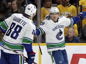Vancouver Canucks center Markus Granlund (60), of Finland, celebrates with Adam Gaudette (88) after Granlund scored against the Nashville Predators during the first period of an NHL hockey game Thursday, April 4, 2019, in Nashville, Tenn.