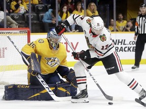 Chicago Blackhawks center Dylan Strome (17) tries to get a shot away in front of Nashville Predators goaltender Pekka Rinne (35), of Finland, during the first period of an NHL hockey game Saturday, April 6, 2019, in Nashville, Tenn.