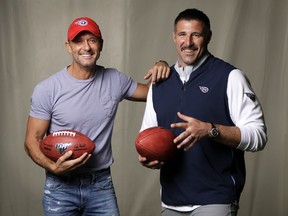 In this April 18, 2019, photo, country music star Tim McGraw, left, poses with Tennessee Titans head coach Mike Vrabel in Nashville, Tenn. After the opening round of the NFL Draft in Nashville on Friday, April 25, McGraw will cap off the evening performing on the draft stage across the Cumberland River from Nissan Stadium, home of the Tennessee Titans.