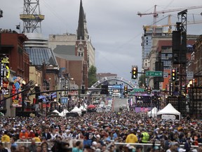Fans watch the main stage ahead of the first round at the NFL football draft, Thursday, April 25, 2019, in Nashville, Tenn.