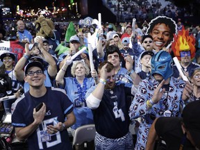Fans watch the action on the main stage during the first round at the NFL football draft, Thursday, April 25, 2019, in Nashville, Tenn.
