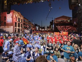 Fans sit on the main stage during the second round of the NFL football draft, Friday, April 26, 2019, in Nashville, Tenn.