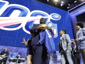 New York Giants fan Greg Hampton, holds a jersey after winning two season tickets for the team for the next century, during in the first round at the NFL football draft, Thursday, April 25, 2019, in Nashville, Tenn. As part of the NFL's celebration of its 100th season, which begins in September, the league held a contest that drew about 5,000 entrants.