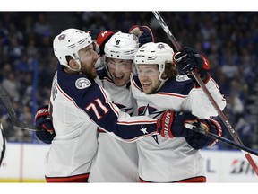 Columbus Blue Jackets defenseman Zach Werenski (8) celebrates his goal against the Tampa Bay Lightning with left wing Nick Foligno (71) and left wing Artemi Panarin (9) during the first period of Game 2 of an NHL Eastern Conference first-round hockey playoff series Friday, April 12, 2019, in Tampa, Fla.