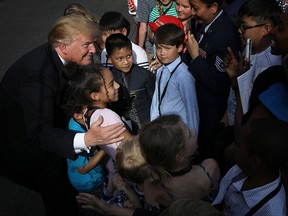 President Donald Trump greets children and their parents on the South Lawn of the White House in Washington on April 25, 2019, as part of the Take Our Daughters and Sons to Work Day at the White House.