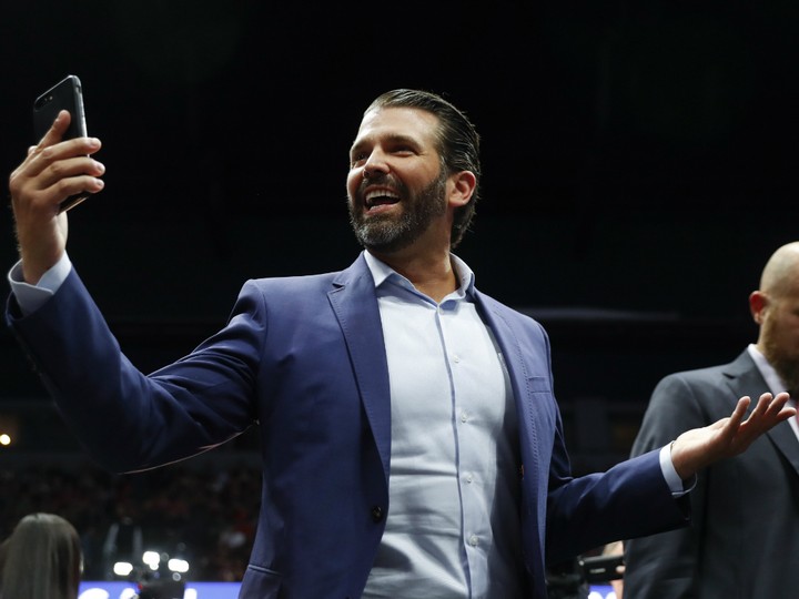  Donald Trump Jr. takes video of the crowd during a rally in Grand Rapids, Mich., Thursday, March 28, 2019. Trump’s eldest son has claimed that social media companies are deliberately targeting Republican accounts for removal.