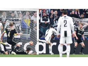 Juventus' Cristiano Ronaldo scores his side's opening goal during the Champions League, quarterfinal, second leg soccer match between Juventus and Ajax, at the Allianz stadium in Turin, Italy, Tuesday, April 16, 2019. .