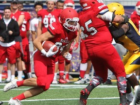 The McGill Redmen's Jacob Dwinnell runs the ball during the second half of exhibition play against the Queen's Gaels at Richardson Stadium in Kingston, Ont. on Saturday August 19, 2017.