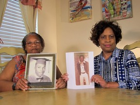 In this Wednesday, April 10, 2019, photo Mylinda Byrd Washington, 66, left, and Louvon Byrd Harris, 61, hold up photographs of their brother James Byrd Jr. in Houston. James Byrd Jr. was the victim of what is considered to be one of the most gruesome hate crime murders in recent Texas history.